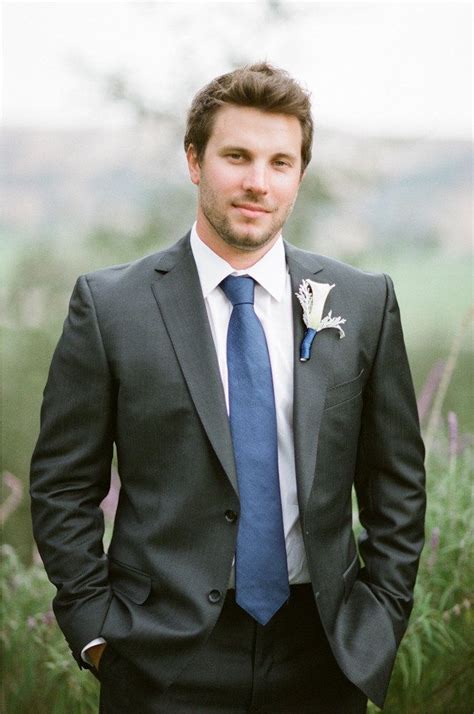 dark charcoal suit blue tie.